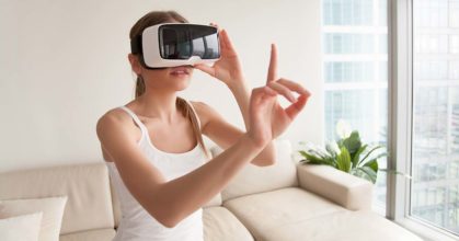 Woman in VR headset touching virtual objects