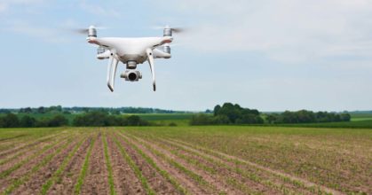 drone quad copter with high resolution digital camera on green corn field