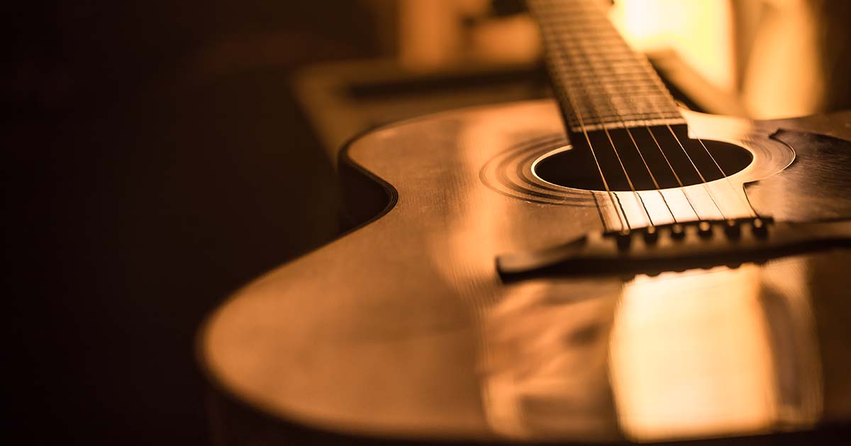 acoustic guitar close-up on a beautiful colored background